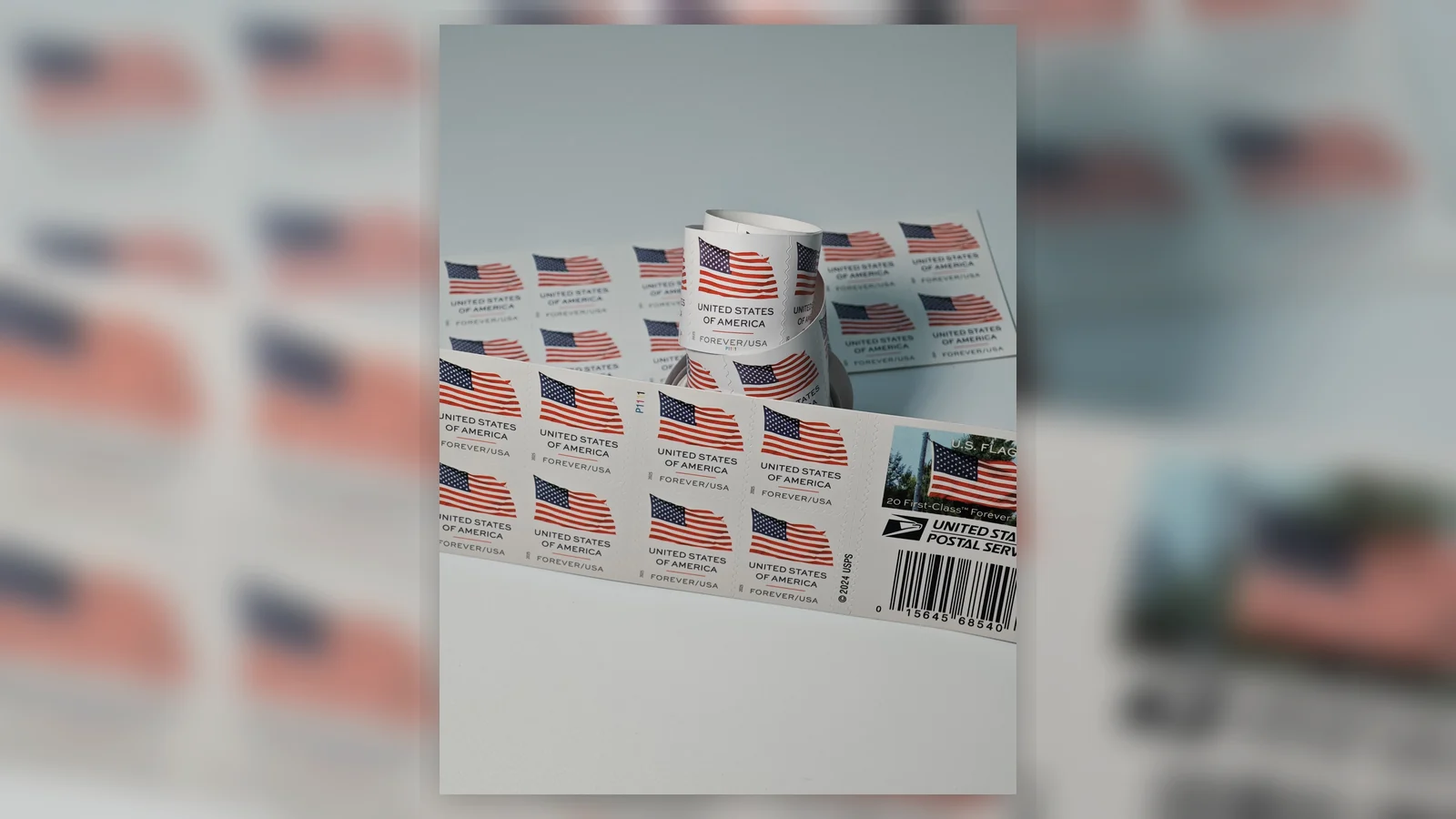 Real U.S. flag postage stamps arranged with envelopes for everyday mail