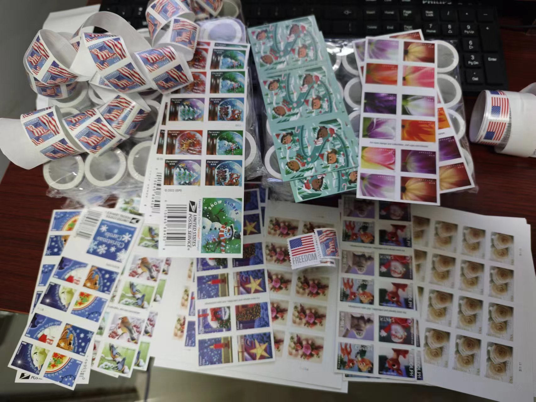 Real U.S. postage stamps arranged with envelopes and thank-you cards for everyday mailing